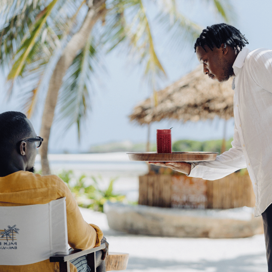 Guests enjoying sunset and cocktails at Palm Beach Watamu